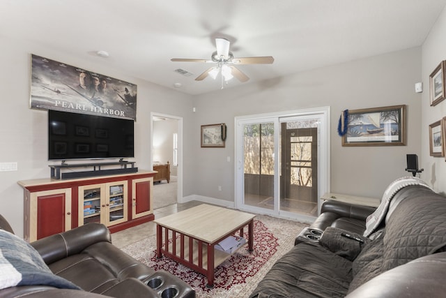 living area featuring baseboards, tile patterned flooring, visible vents, and a ceiling fan