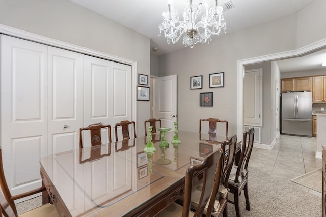 dining room featuring visible vents, a notable chandelier, baseboards, and light tile patterned floors