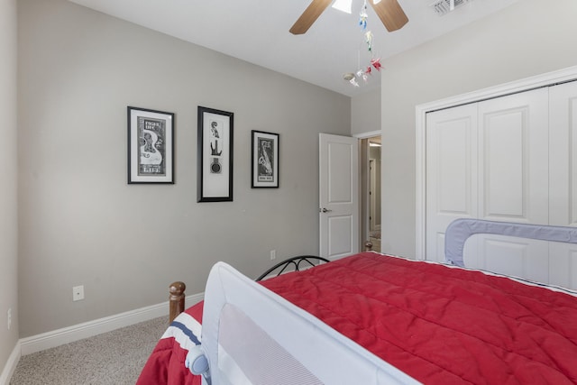 carpeted bedroom with a ceiling fan, visible vents, vaulted ceiling, baseboards, and a closet