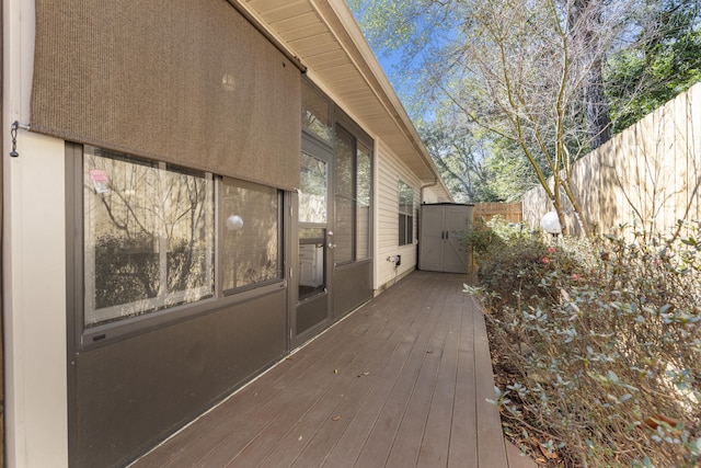 wooden terrace featuring fence