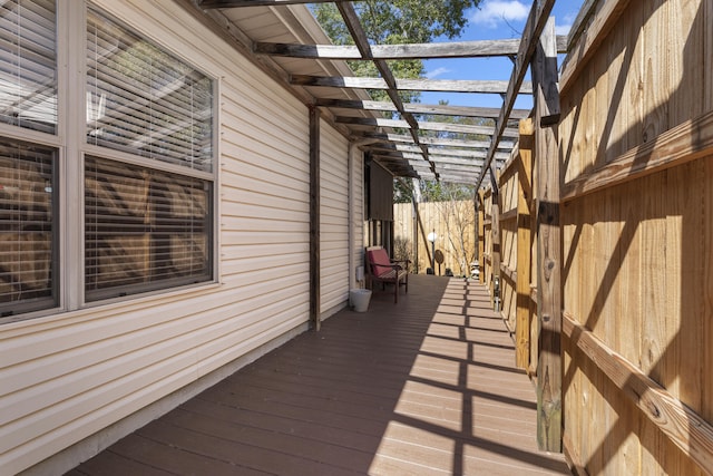 wooden terrace featuring fence and a pergola