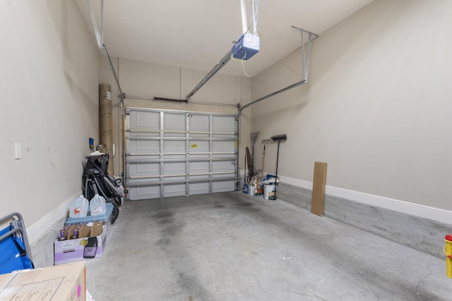 garage with a garage door opener and baseboards