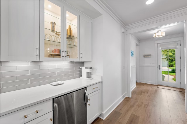 kitchen featuring light countertops, glass insert cabinets, and white cabinets