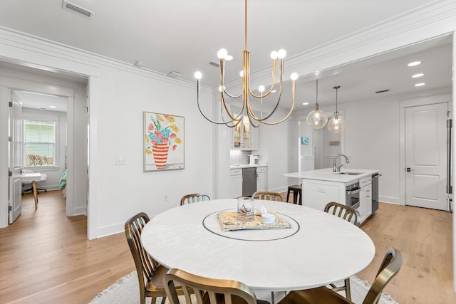 dining area with light wood-style floors, visible vents, and crown molding