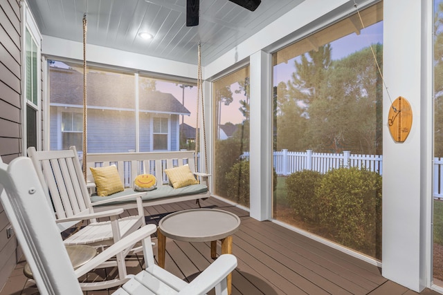 sunroom / solarium featuring ceiling fan