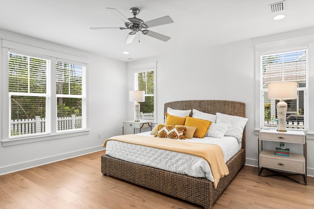 bedroom with recessed lighting, visible vents, light wood-style flooring, a ceiling fan, and baseboards