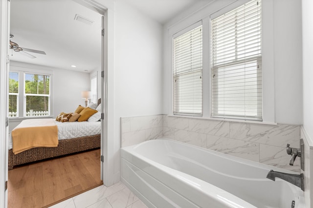 bathroom featuring visible vents, ceiling fan, ensuite bath, and a bath