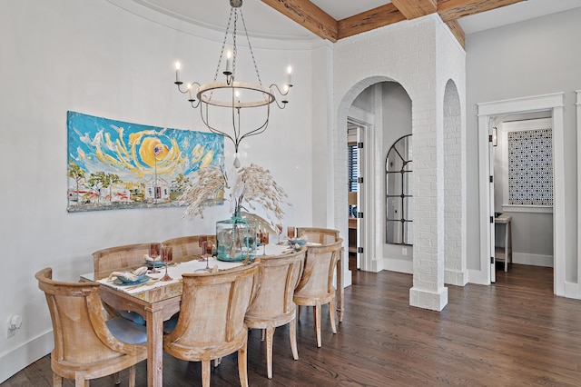 dining room featuring arched walkways, wood finished floors, beam ceiling, and baseboards