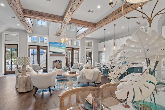 living room featuring french doors, a notable chandelier, beamed ceiling, and wood finished floors