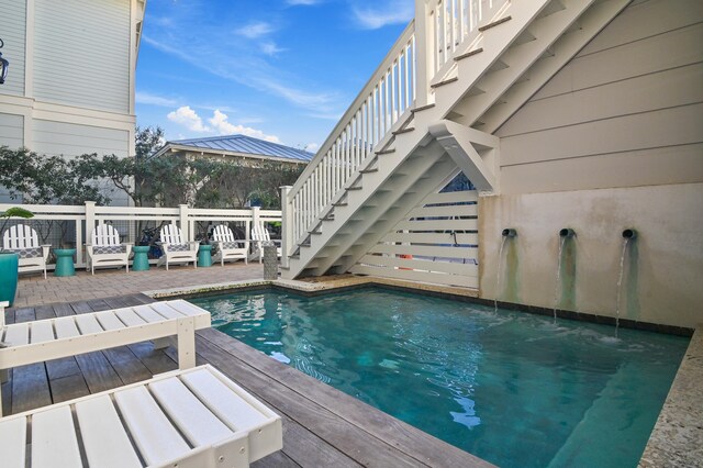 view of swimming pool featuring a deck and stairway