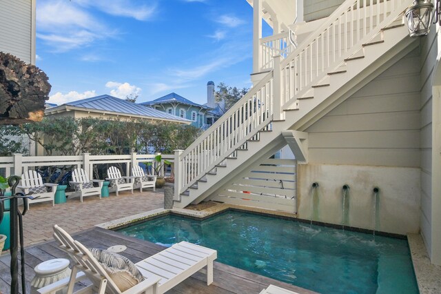 view of swimming pool with stairway