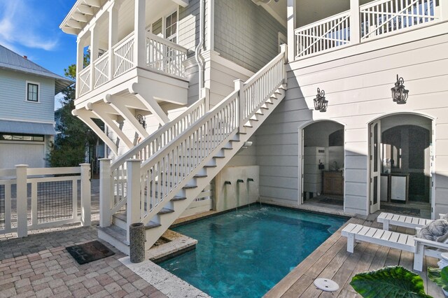 outdoor pool featuring stairway