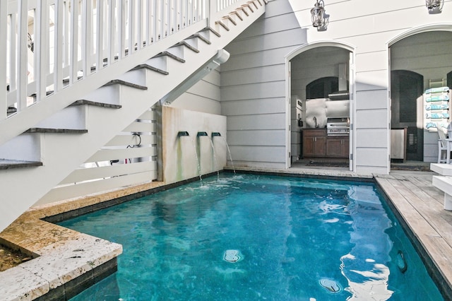 view of pool featuring grilling area