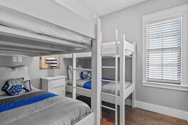 bedroom with baseboards and wood finished floors