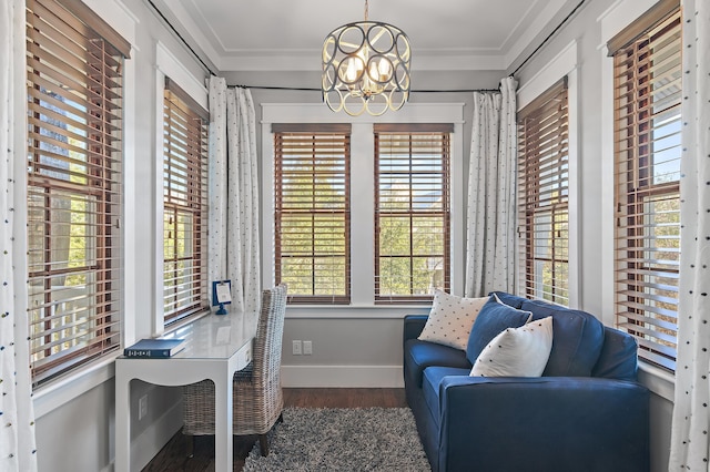 office space featuring a chandelier, crown molding, wood finished floors, and baseboards