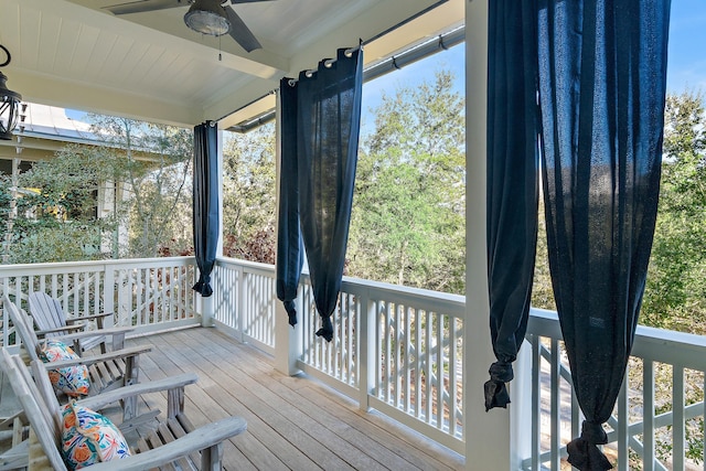 wooden deck featuring ceiling fan