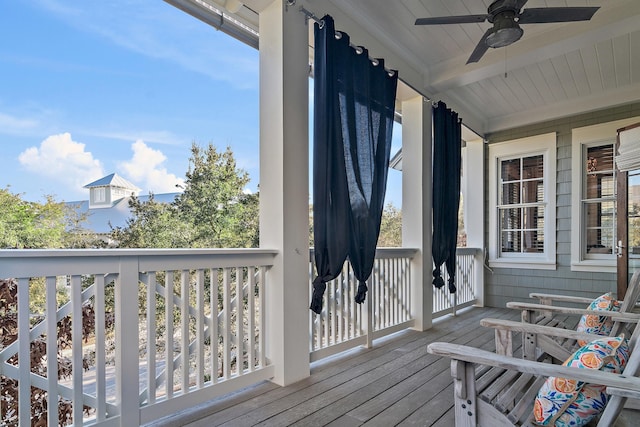 wooden deck featuring a ceiling fan