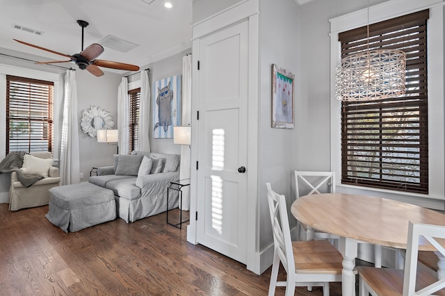 interior space featuring ceiling fan, visible vents, and dark wood-type flooring