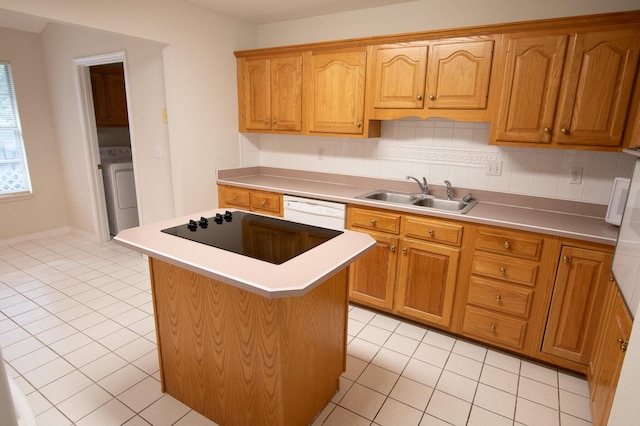 1700 Dellmont Cv, Niceville, FL 32578 - kitchen with a sink, washer / clothes dryer, light tile patterned floors, white dishwasher, and a kitchen island