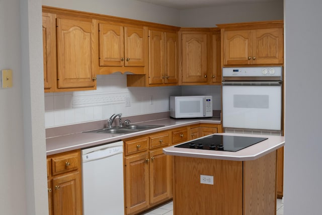1700 Dellmont Cv, Niceville, FL 32578 - kitchen featuring white appliances, a sink, a center island, light countertops, and light tile patterned floors