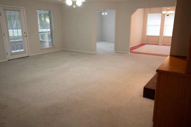 1700 Dellmont Cv, Niceville, FL 32578 - spare room with carpet floors, a chandelier, a ceiling fan, and baseboards