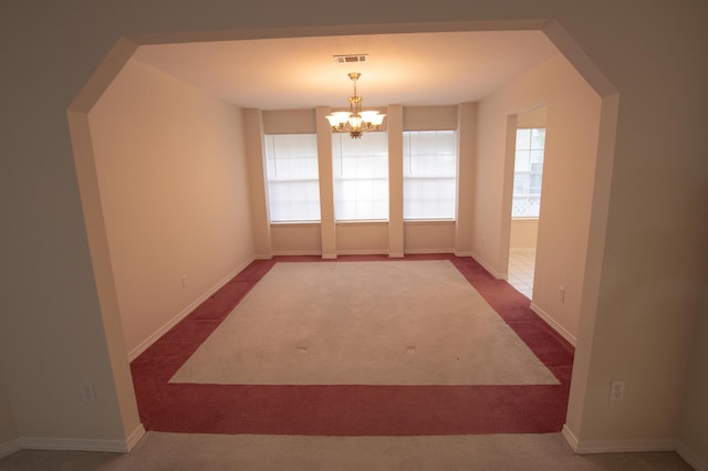 1700 Dellmont Cv, Niceville, FL 32578 - unfurnished dining area with a chandelier, dark carpet, and baseboards