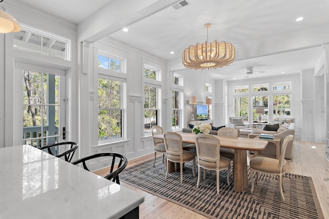 sunroom / solarium with an inviting chandelier and visible vents