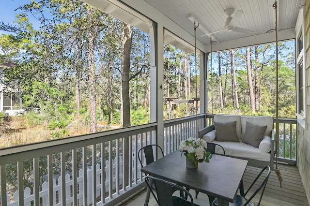 sunroom / solarium with a ceiling fan