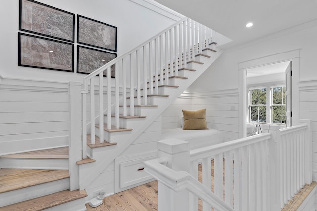 staircase with recessed lighting and wood finished floors