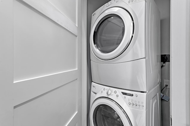 clothes washing area with laundry area and stacked washer and clothes dryer