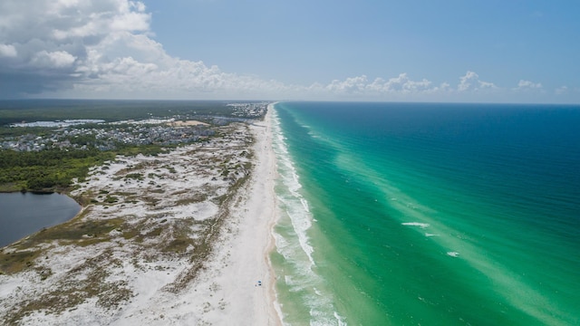 aerial view with a water view and a view of the beach