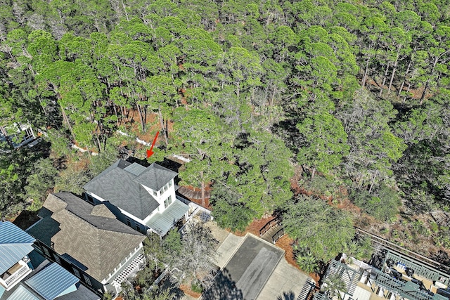 bird's eye view with a wooded view