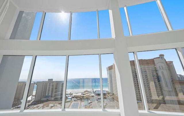 unfurnished sunroom featuring a water view