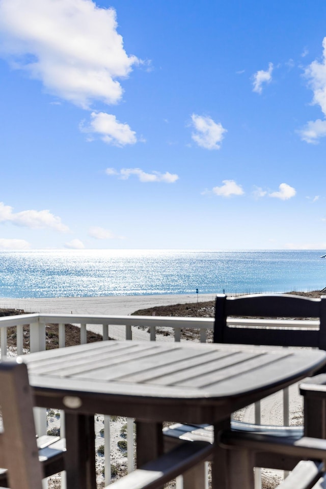 surrounding community featuring a view of the beach and a water view