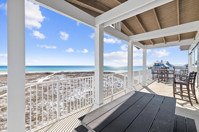 exterior space with a water view and a view of the beach