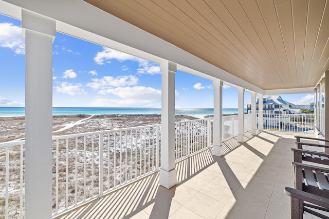 balcony featuring a water view and a view of the beach