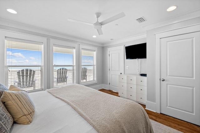 bedroom featuring ornamental molding, recessed lighting, visible vents, and wood finished floors