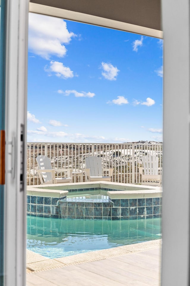 view of swimming pool featuring a pool with connected hot tub