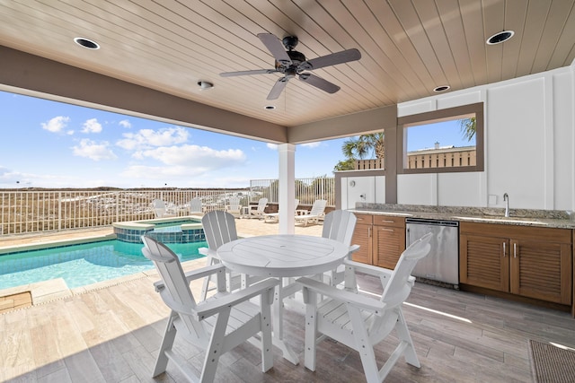 view of patio / terrace featuring ceiling fan, a fenced backyard, a sink, a pool with connected hot tub, and an outdoor bar