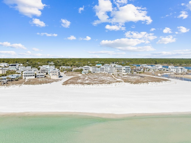 drone / aerial view featuring a water view and a beach view