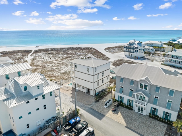 bird's eye view with a water view and a beach view