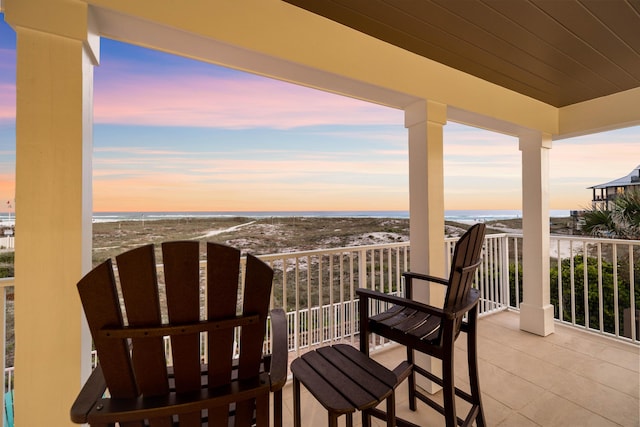 balcony with a beach view and a water view