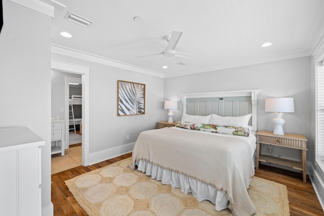 bedroom featuring baseboards, visible vents, ornamental molding, wood finished floors, and recessed lighting