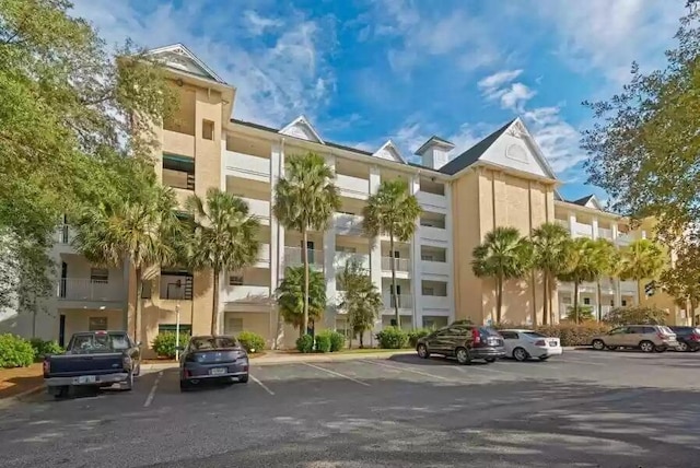 view of property featuring uncovered parking