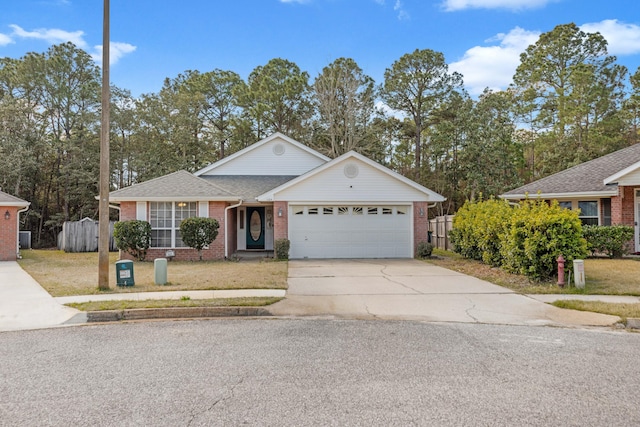 single story home featuring brick siding, a shingled roof, a front yard, a garage, and driveway