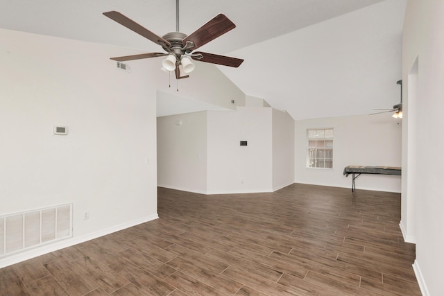 spare room with dark wood-style flooring, visible vents, ceiling fan, and baseboards