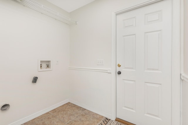 laundry area with washer hookup, laundry area, light tile patterned flooring, and baseboards