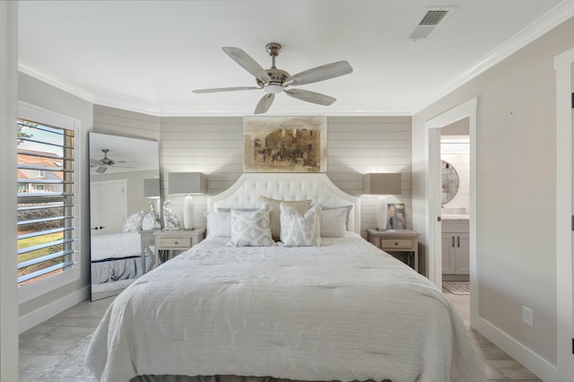 bedroom featuring visible vents, crown molding, light wood-style flooring, and baseboards