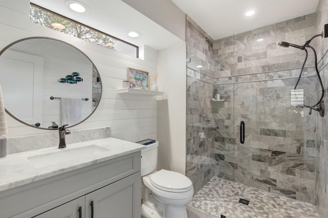 full bathroom featuring toilet, a stall shower, vanity, and recessed lighting