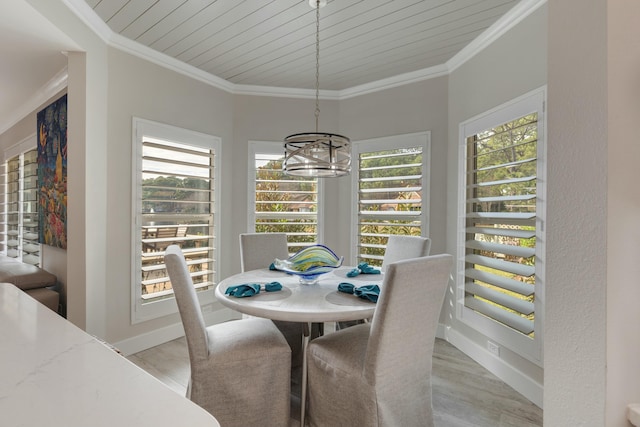 dining room with crown molding, baseboards, and an inviting chandelier